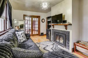 a living room with a couch and a fireplace at 1 Mi to Downtown Dubuque! Spacious Home in Dubuque