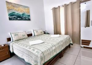 a bedroom with a bed with two pillows on it at Gypsy Walker Plus in Varkala