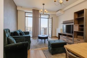 Una sala de estar con un sofá y un televisor en Belgrade Waterfront Residences, en Belgrado