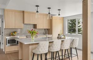 a kitchen with a counter and stools in it at Ski-In Ski-Out Escape with Mountain Views in Snowm in Snowmass Village
