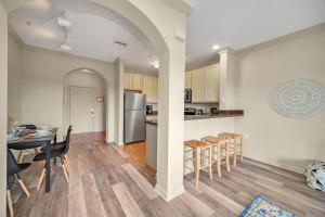 a kitchen and dining room with a table and chairs at 2BR Condo with pool, near Disney! in Orlando