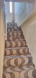 a set of stairs with a mosaic tile floor at Hospedagem da Fran in Brasilia