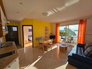 a living room with a couch and a table at Apartmani Vanessa in Dramalj