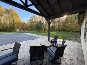 a patio with chairs and a table and a basketball court at Private 5-Acre Retreat In-Ground Pool Hot Tub in Oberlin