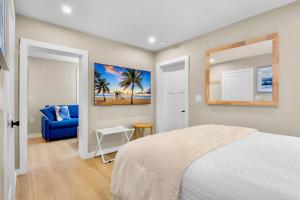 a bedroom with a bed and a blue couch at Haley's at Anna Maria Island Inn in Holmes Beach