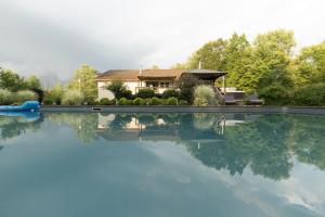 a house is reflected in the water of a swimming pool at Private 5-Acre Retreat In-Ground Pool Hot Tub in Oberlin