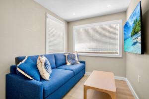 a blue couch in a living room with a table at Haley's at Anna Maria Island Inn in Holmes Beach