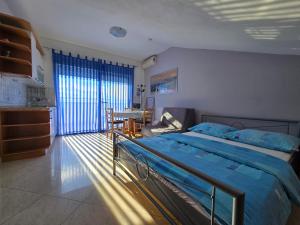 a bedroom with a bed and a table in it at Apartmani Vanessa in Dramalj