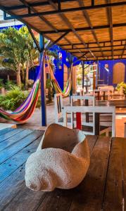 a rock sitting on top of a wooden table with a hammock at Hotel Chuburna in Chuburná