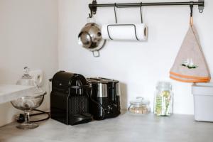 a kitchen counter with a coffee maker and a toaster at Gîte de la maraîchère in Ittre +13 photos