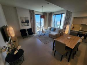 an overhead view of a living room with a table and chairs at Elite 2BR Abode Distinctive Living at The Shores in Manama