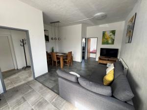 a living room with a couch and a dining room at Wohnung 6 Toni in Oedt