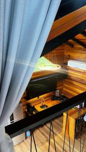 a room with a curtain and a kitchen with a sink at The Valley Cabin in Barracão