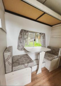 a white table and chairs in a tiny house at Costa Traful in Villa Traful