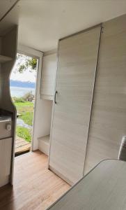 a sliding door in a kitchen with a view at Costa Traful in Villa Traful +47 photos