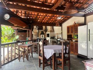 een keuken en eetkamer met een tafel en stoelen bij Itamambuca Suites in Ubatuba