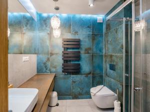 a bathroom with a toilet and a sink at Osada Gubałówka na Polanie Pająkówka View Jacuzzi & Sauna in Kościelisko +216 photos