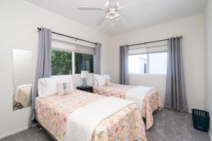 two beds in a room with two windows at 304 Ruby Ave B in Newport Beach +6 photos