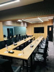 a large conference room with a long table and chairs at Signature Boutique Hotel Karachi in Karachi