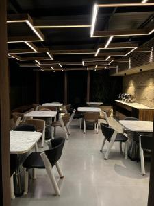 a dining room with tables and chairs and lights at Signature Boutique Hotel Karachi in Karachi