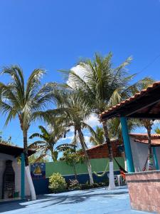 a group of palm trees in front of a building at Joia do Paraiso - Macapá Luís Correia in Luis Correia