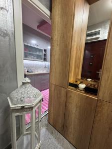 a kitchen with a large wooden door and a table at Analadyboss in Leskovac