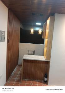 a kitchen with a counter with two lights above it at Hospedaje Búho's E in Guayaquil