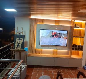 a large flat screen tv on a wall at Hospedaje Búho's E in Guayaquil