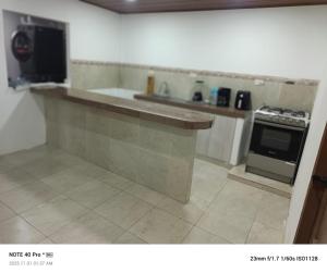 a kitchen with a counter and a stove top oven at Hospedaje Búho's E in Guayaquil