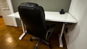a black office chair sitting at a white desk at Apartamento felicitat in Figueres
