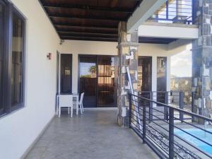 a balcony of a house with a table and chairs at residence exotica in Île aux Chats