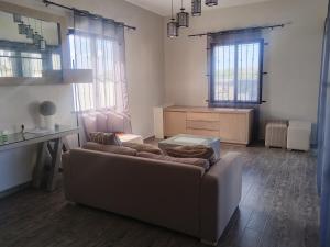 a living room with a couch and a table at residence exotica in Île aux Chats