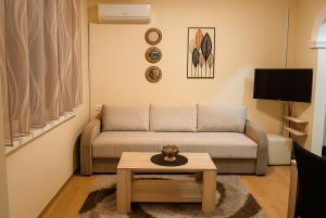 a living room with a couch and a coffee table at Kuća Amazonija in Apatin +37 photos