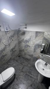 a bathroom with a toilet and a sink at Hidden Treasure in Nuwara Eliya