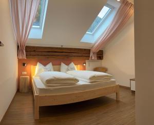 a bedroom with a bed with a skylight at Hanselerhof Jaufental Ratschings mit Sauna in Racines