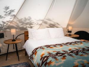 Ένα ή περισσότερα κρεβάτια σε δωμάτιο στο Spacious Dual Bell Tent Glamping Retreat with Forest Deck near Carson, Washington