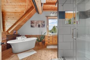 a bathroom with a tub and a glass shower at Hébergement "La Maison en Bois Rond" in Sainte-Marie +31 photos