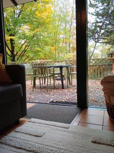 a door leading to a patio with a table and chairs at Mon CoCoo in Stavelot +26 photos