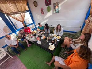 a group of people sitting around a table at TISLIT Surf Taghazout in Taghazout +56 photos