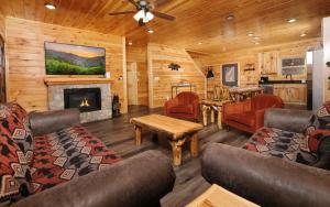 a living room with couches and a fireplace at Cate + Cali's Place - Private Indoor Pool, Game Room + Outdoor Hot Tub in Pigeon Forge