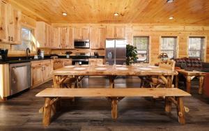 a large dining room with a table and a kitchen at Cate + Cali's Place - Private Indoor Pool, Game Room + Outdoor Hot Tub in Pigeon Forge