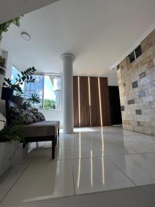 a living room with a couch and a large window at Habitación en la ciudad de Francisco de Orellana in Francisco de Orellana