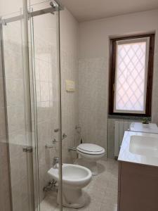 a bathroom with a toilet and a sink and a shower at Maison della Presolana in Songavazzo