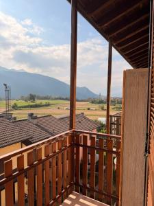 a balcony of a house with a view of the mountains at Maison della Presolana in Songavazzo