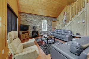 a living room with a couch and a television at The Dreamer - Skiing - Spa - Outdoor and Relaxation in Petite-Rivière-Saint-François