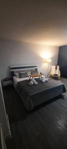 a bedroom with a large bed with a table on it at Garsoniera Mihaela in Craiova