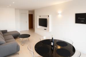 a living room with a table and a couch at Riverside Toulouse (Savory) in Blagnac