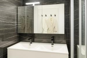 a bathroom with a white sink and a mirror at Riverside Toulouse (Savory) in Blagnac