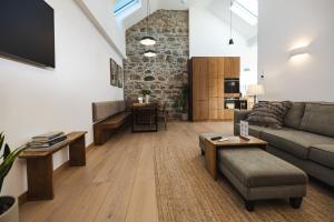 a living room with a couch and a table at WITHIN THE VILLAGE in Roundstone