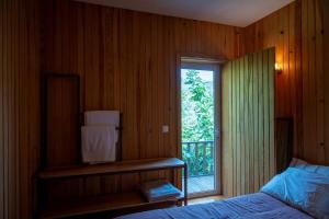 a bedroom with a bed and a window with a balcony at WABI SABI-QuintAlão in Passô +59 photos